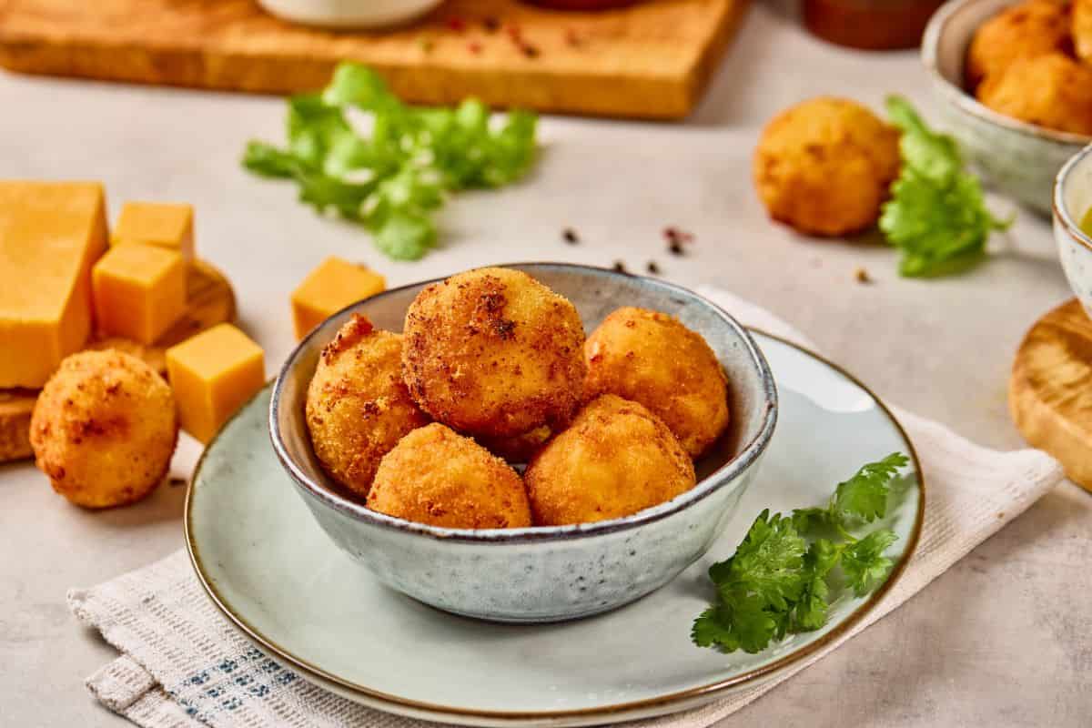 Golden fried cheese balls served with fresh herbs. Perfect for snacks, appetizers, or party platters. Crispy, cheesy, delicious comfort food.