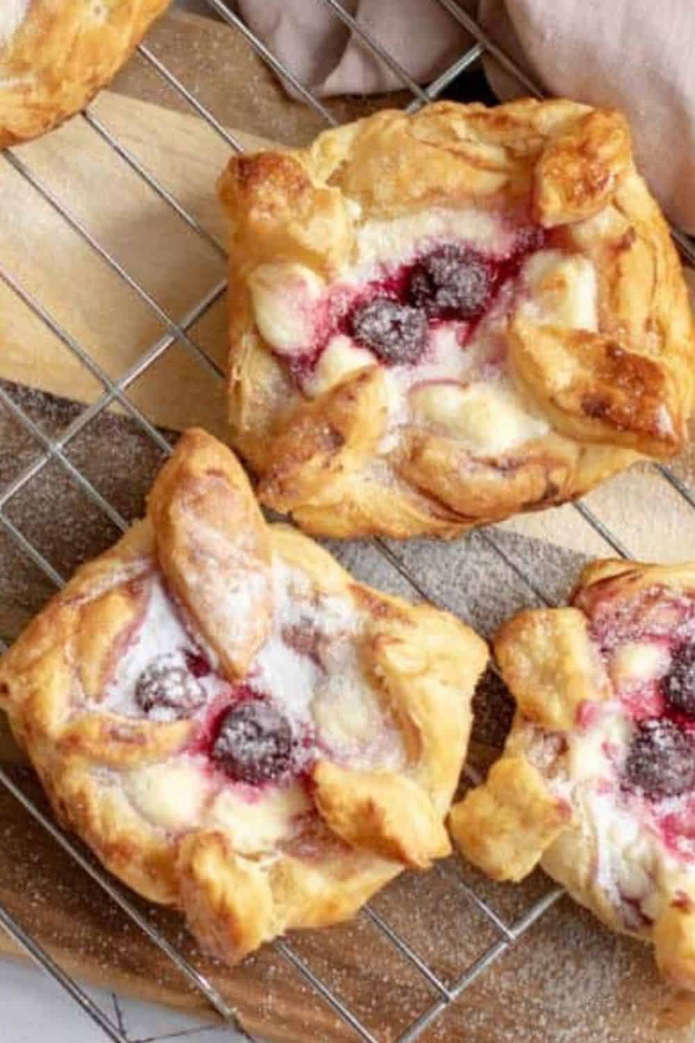 Delicious homemade Danish pastry with berries, cream, and flaky golden layers. Perfect for breakfast or dessert.