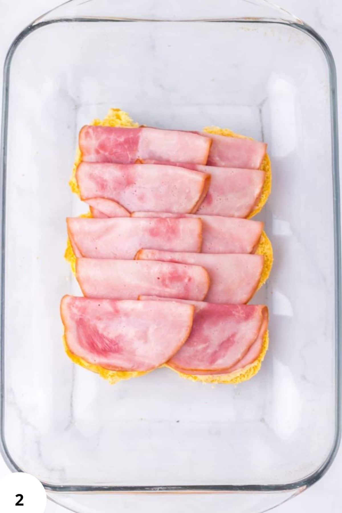 Sandwich ready to assemble with ham slices on bread.