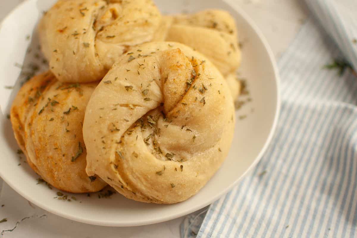 Soft, homemade bread rolls infused with herbs, perfect for dinner or snacks.