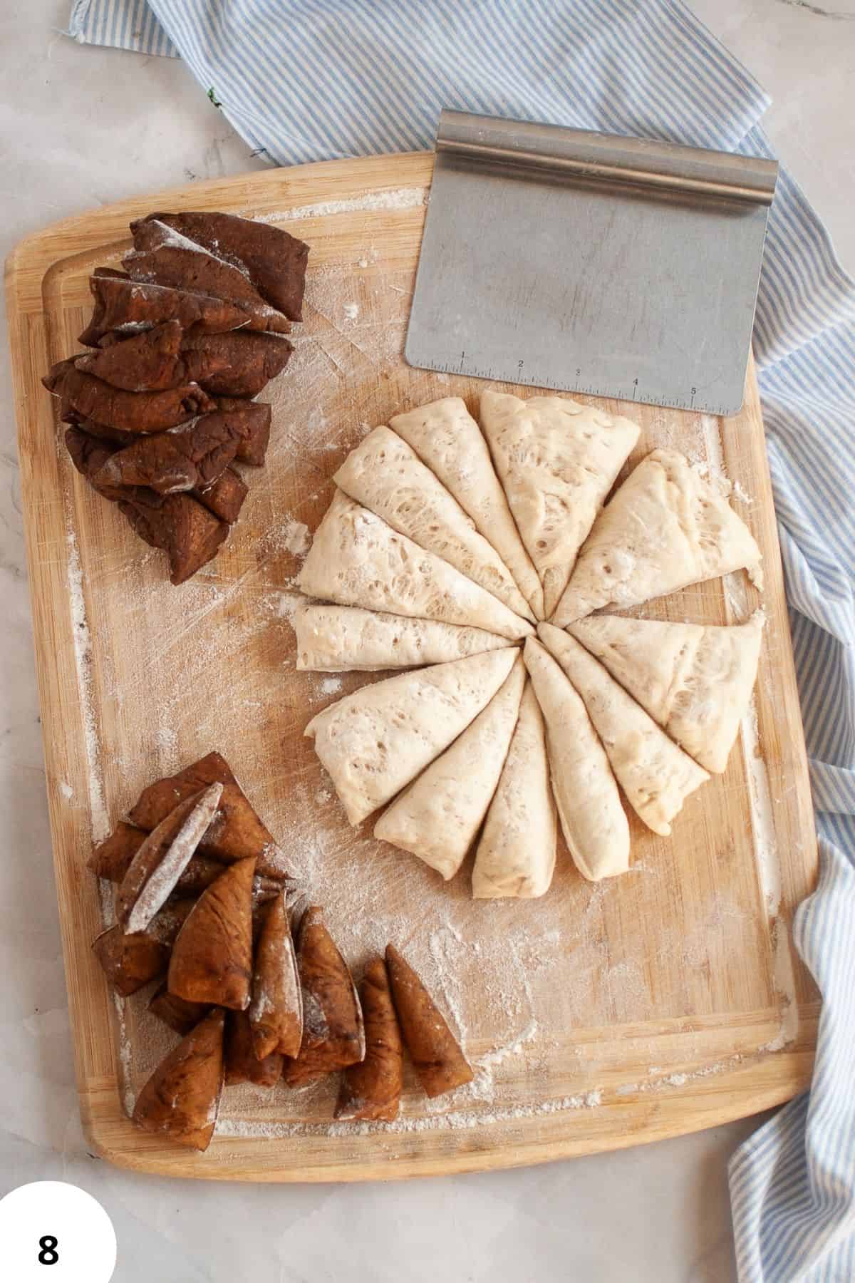Delicious homemade pastries arranged for baking, showcasing bread preparation techniques on a rustic wooden cutting board.