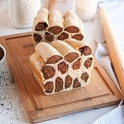 Delicious bread with chocolate chip folds on a wooden cutting board for baking and bread-making.