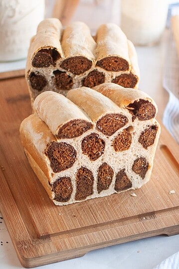 Delicious bread with chocolate chip folds on a wooden cutting board for baking and bread-making.