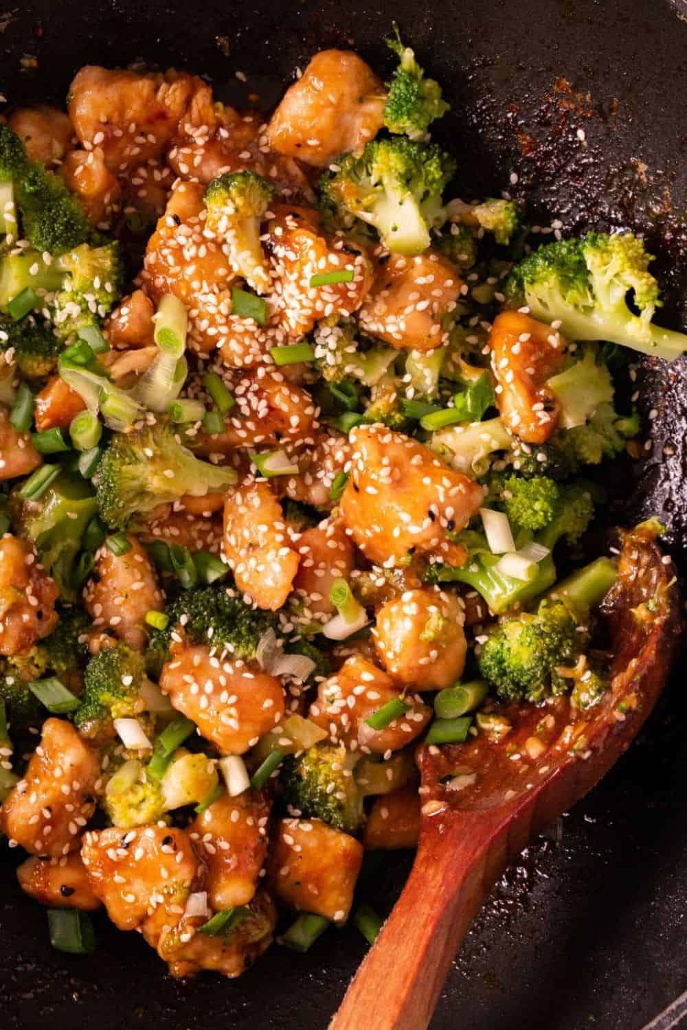 Delicious stir-fried chicken and broccoli dish topped with sesame seeds, cooked in a savory sauce.