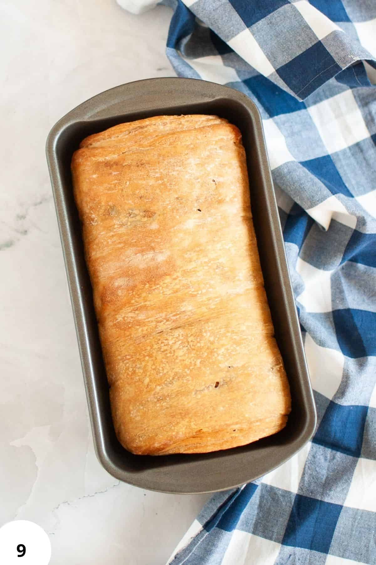 Durable loaf pan with rising dough for homemade bread, featuring stretch and fold techniques.