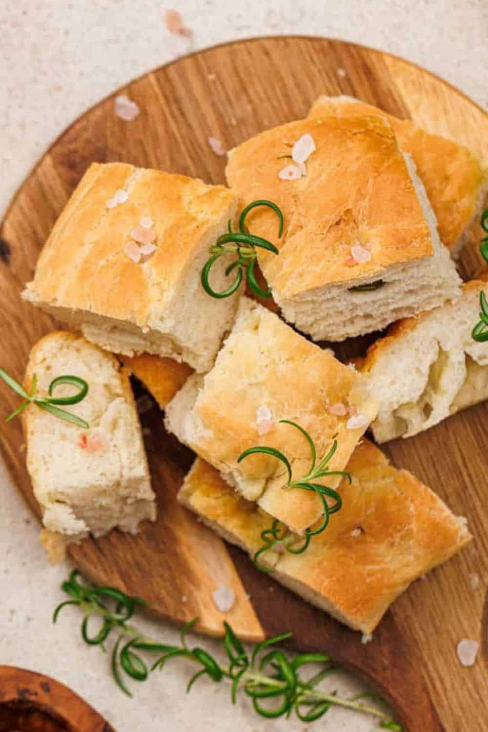 Soft homemade bread cubes garnished with herbs and sea salt, perfect for meals or snacking.