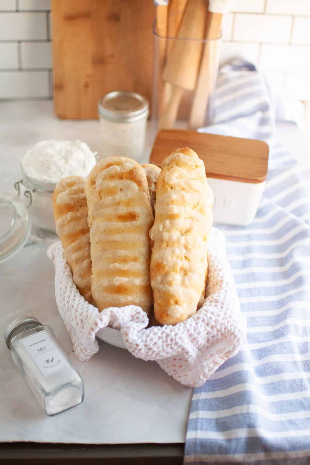 Freshly baked bread rolls on a cloth, highlighting the stretch and fold process.
