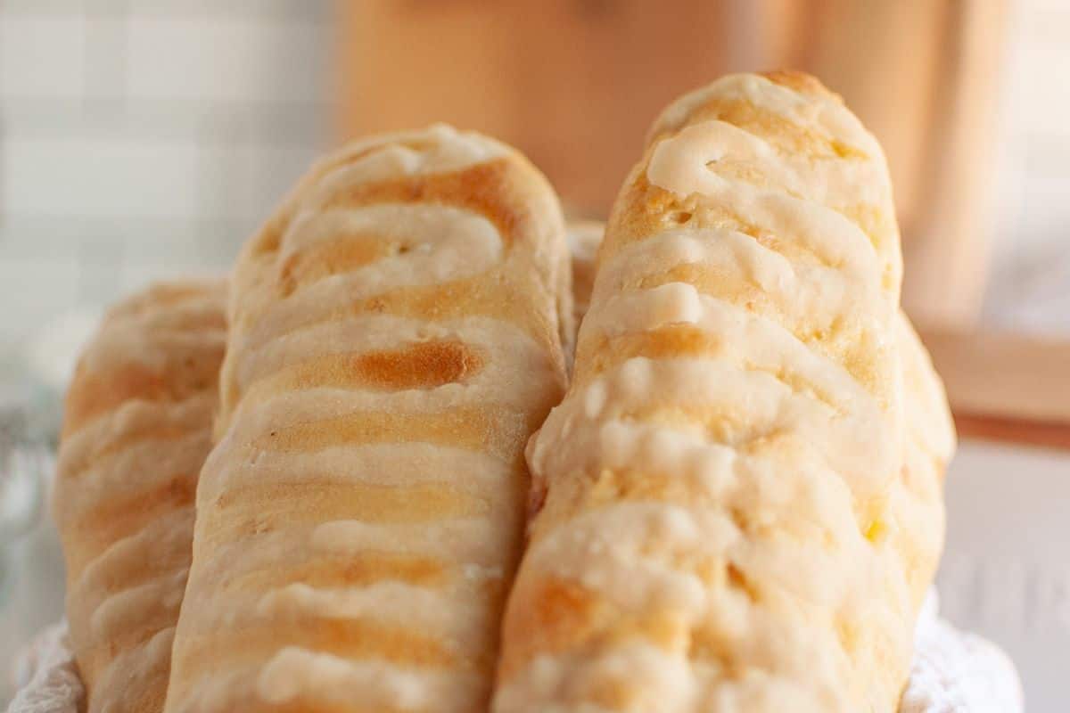 Delicious flaky croissants with a golden crust and shiny glaze, showcasing perfect stretch and folds in dough.