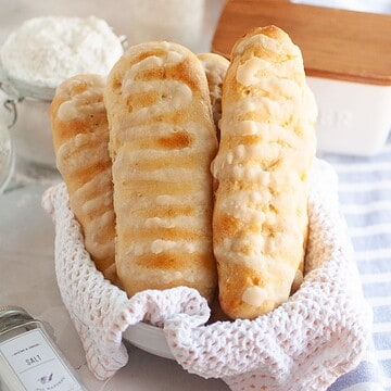 Delicious homemade bread sticks with icing, ideal for baking enthusiasts and bread lovers.