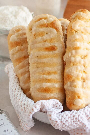 Delicious homemade bread sticks with icing, ideal for baking enthusiasts and bread lovers.