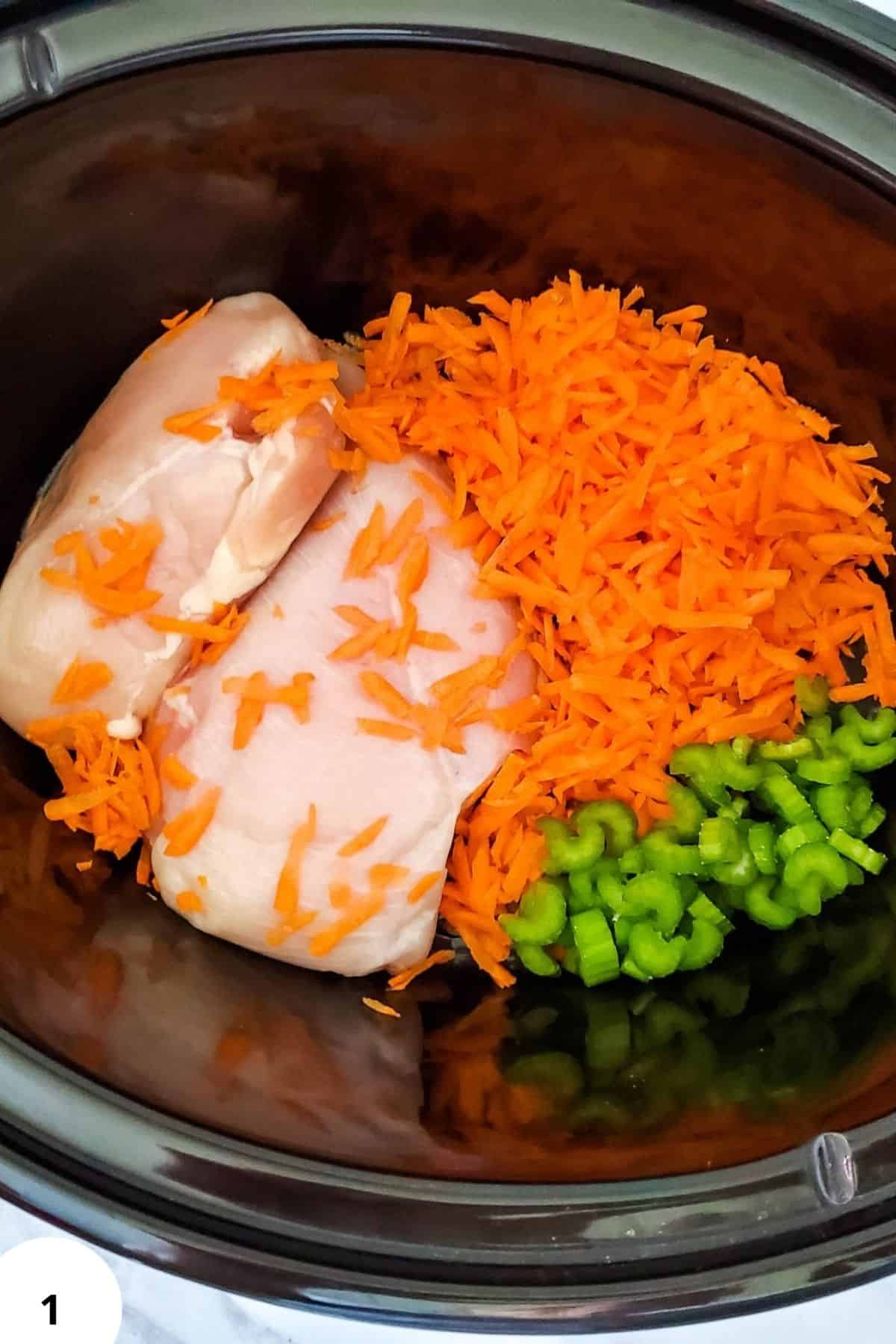 Delicious chicken with chopped carrots and celery in a slow cooker. Perfect for homemade meals.