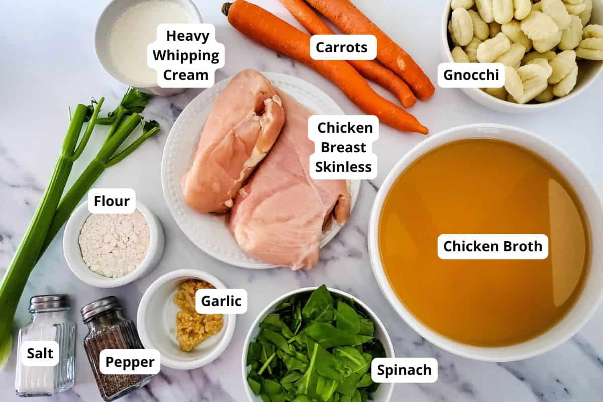 Delicious creamy chicken gnocchi soup with fresh spinach, carrots, and seasoned chicken in a savory broth. Perfect for cozy meals.