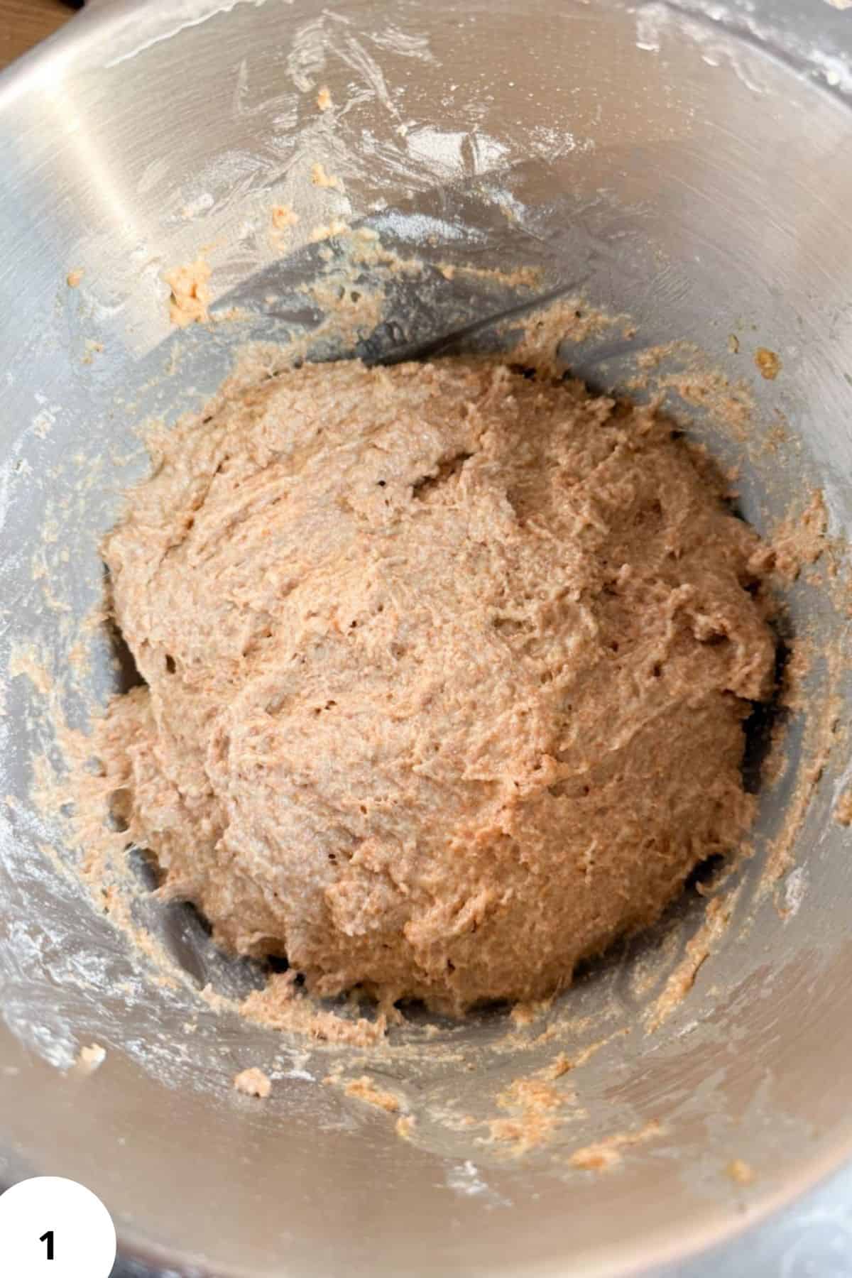 Clean, close-up of freshly mixed dough in a mixing bowl, highlighting the process of fresh milling for baking recipes.