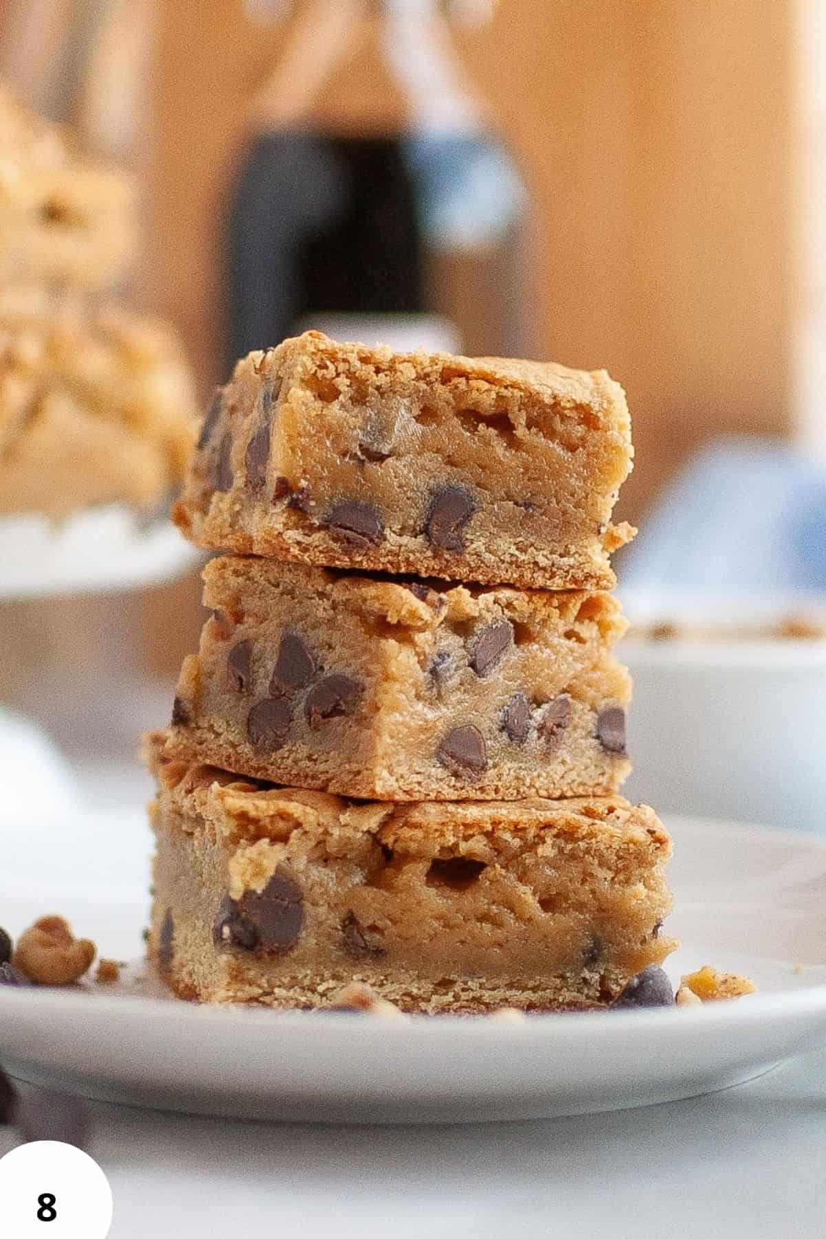 Delicious chocolate chip cookie bars stacked on a plate, showcasing fresh baked goods.