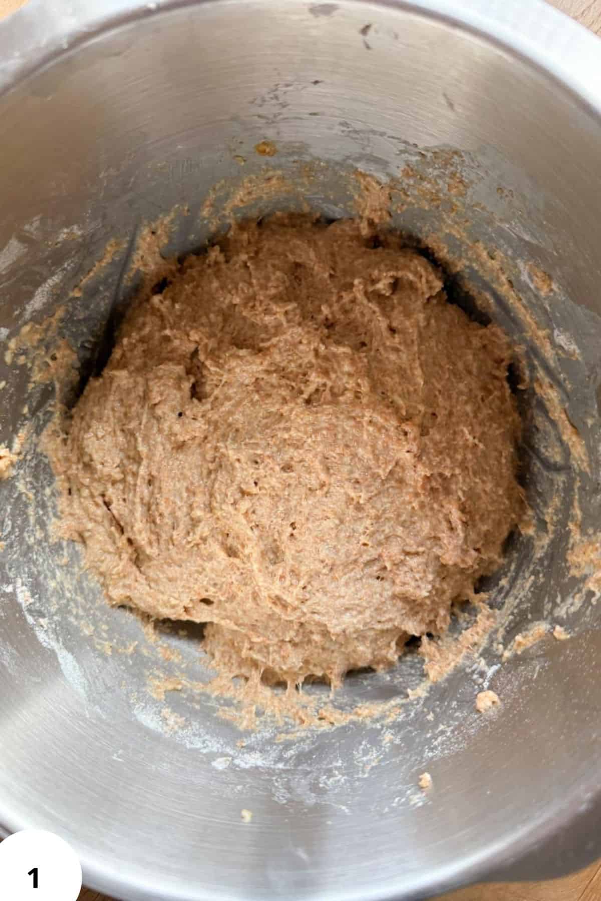 Close-up of freshly milled whole grain flour in a metal mixing bowl.