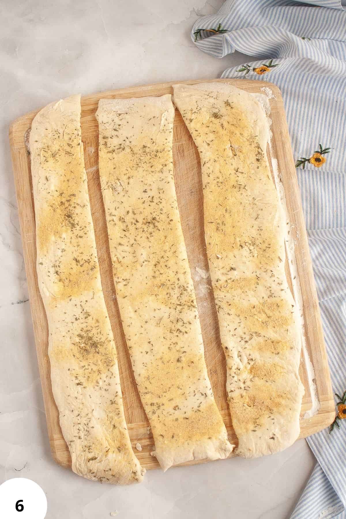 Freshly proofed bread dough with herbs, ideal for stretch and fold bread baking.