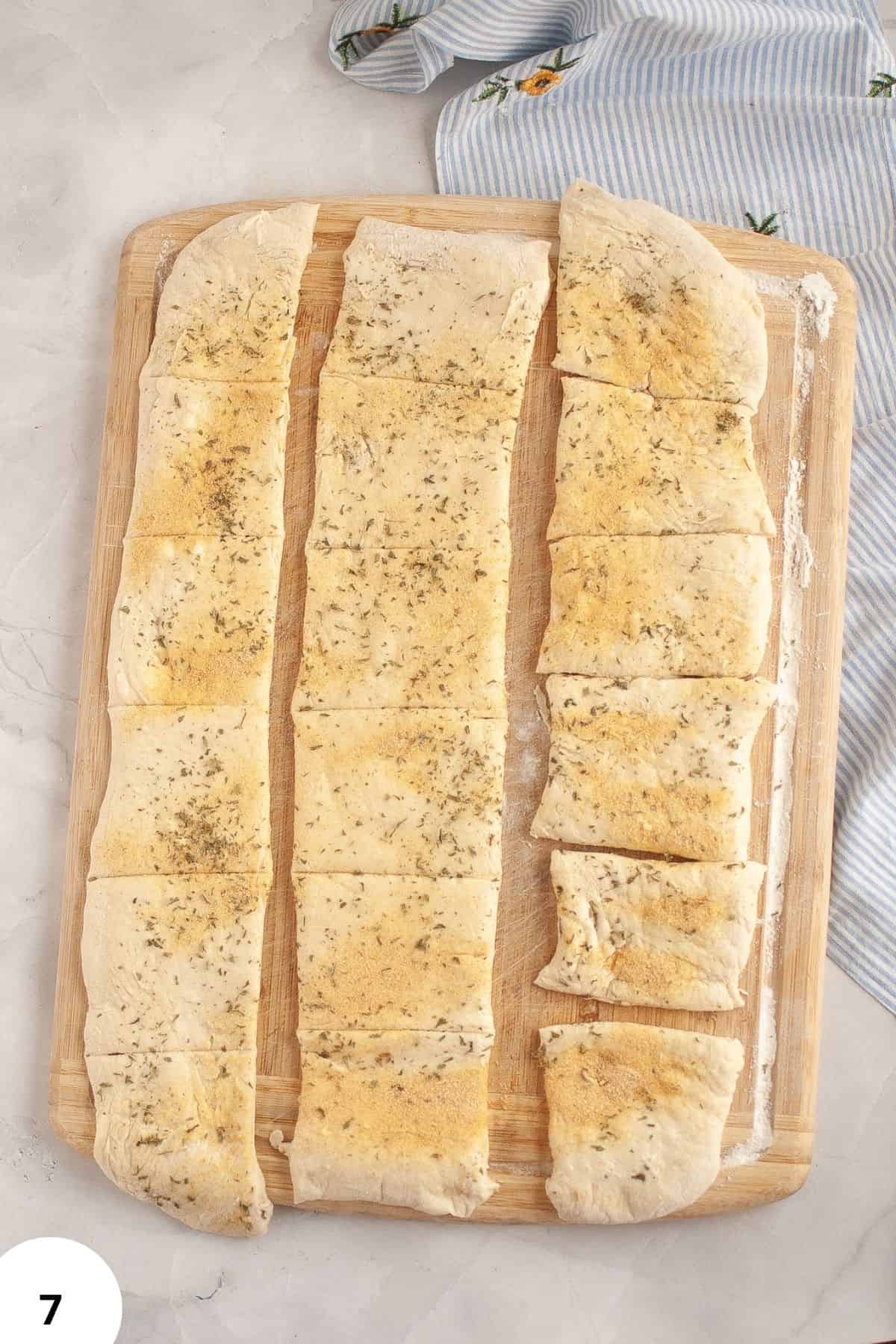 Stretch and fold method used for dough preparation, demonstrated with seasoned pizza dough ready to bake.