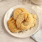 Freshly baked bread rolls seasoned with herbs, ideal for baking and bread recipes.