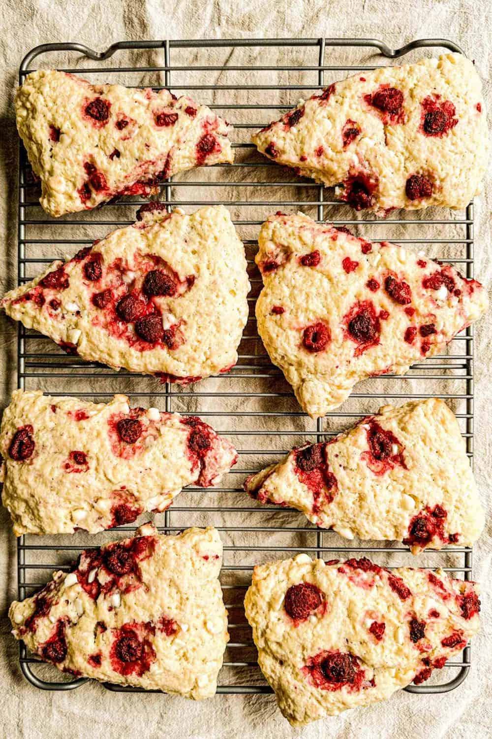 A close-up of raspberry scones with a golden crust and berry filling, ideal for homemade baked goods and baking tutorials.