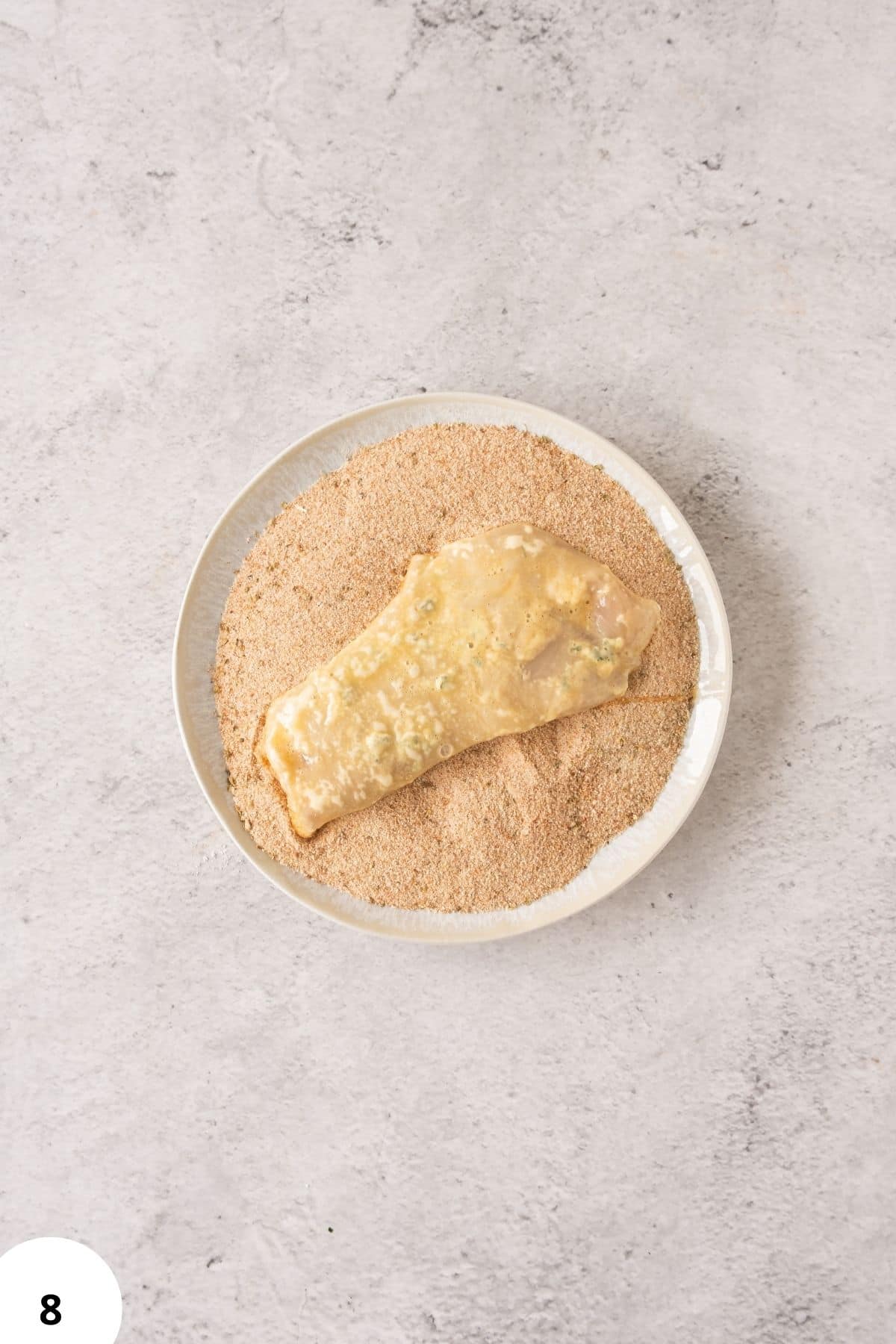 Folding bread dough in a dish.