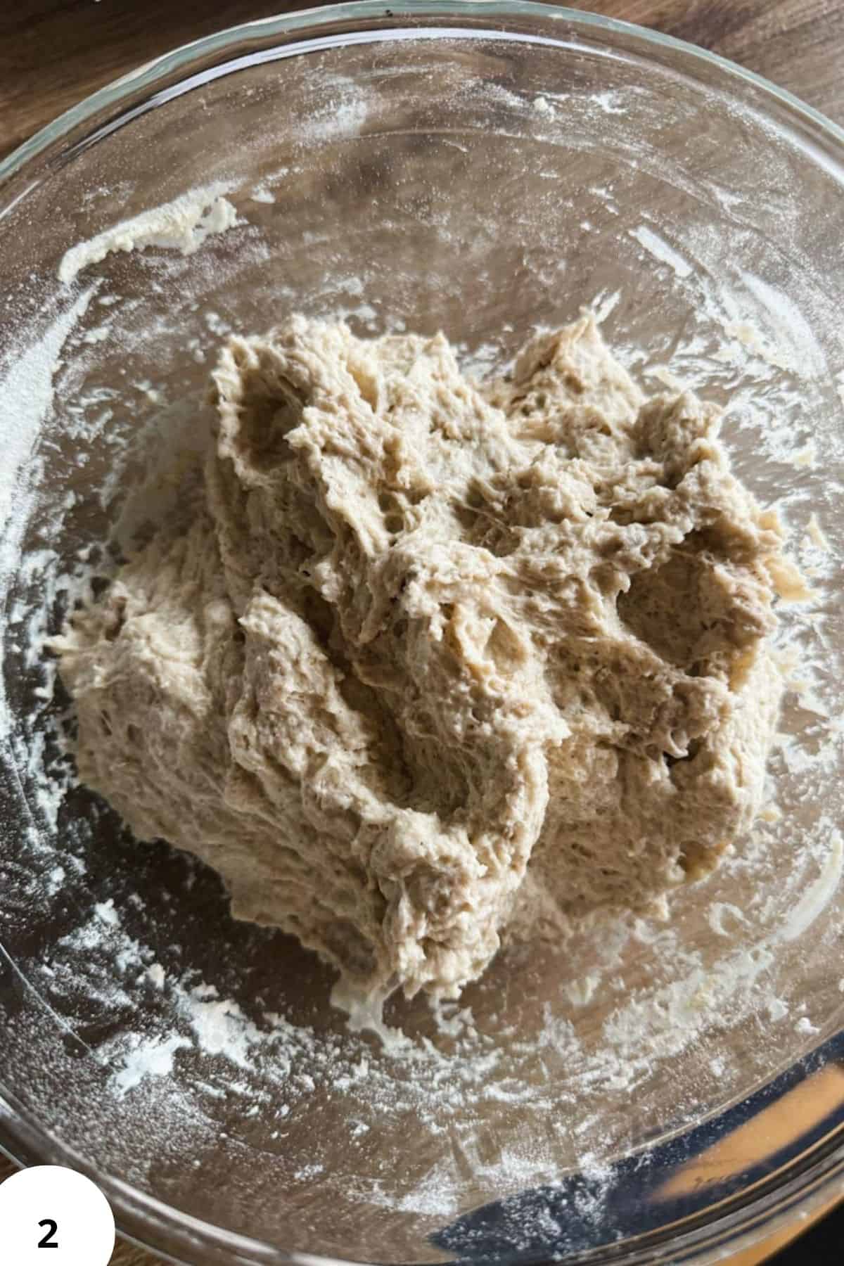 Sourdough bread dough with buckwheat and simple buckwheat scald in a glass bowl.