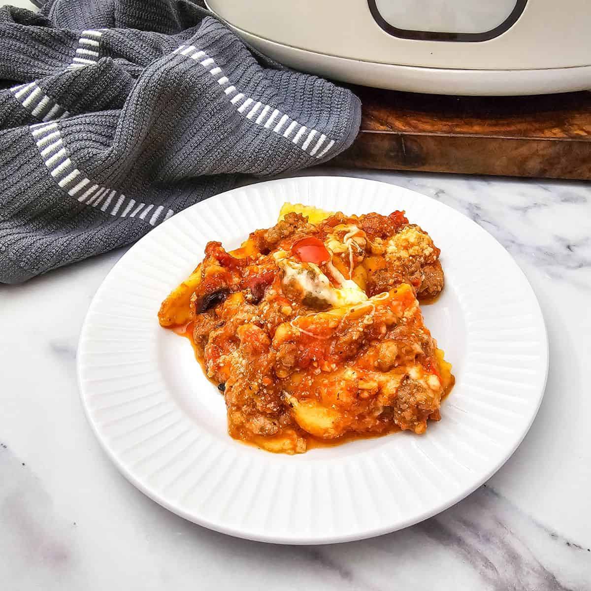 Delicious homemade meatloaf with tomato sauce on a white plate.