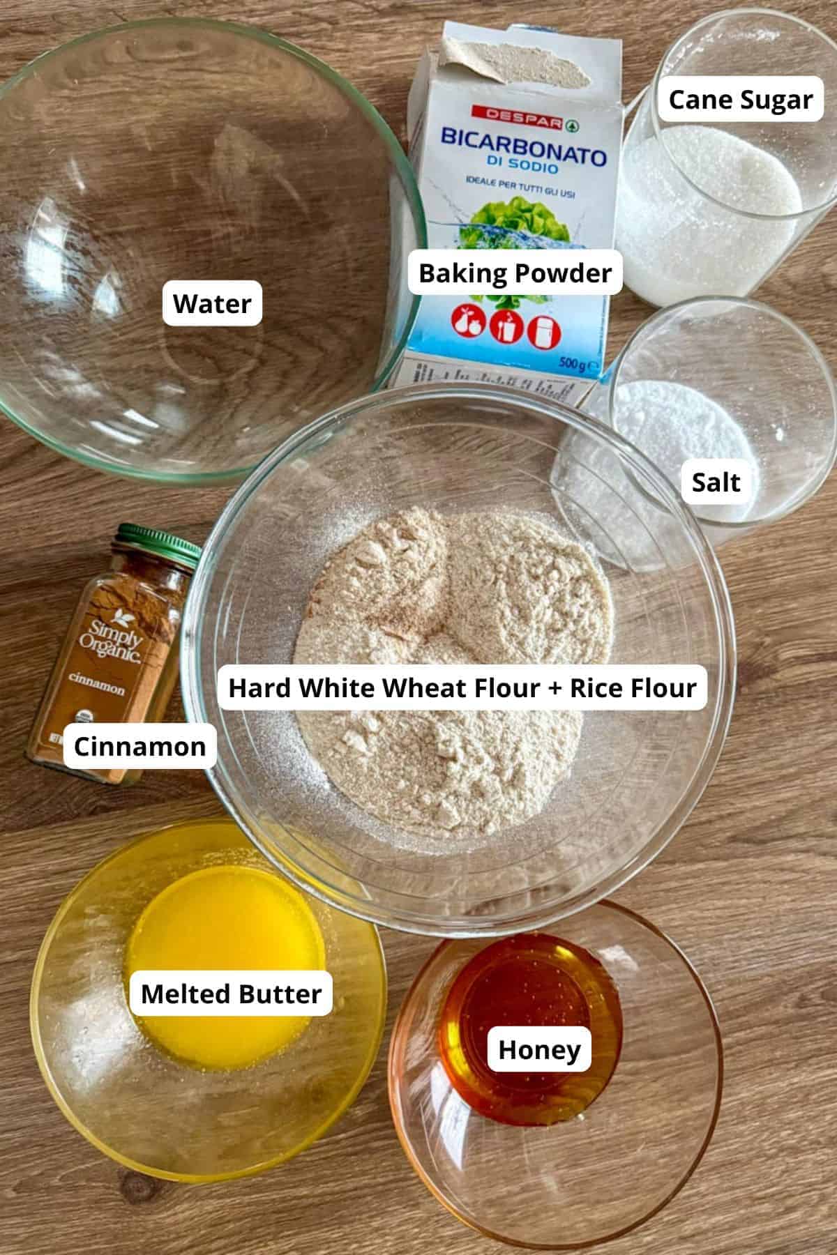 Assorted ingredients including flour, sugar, cinnamon, honey, and butter for cereal recipe.