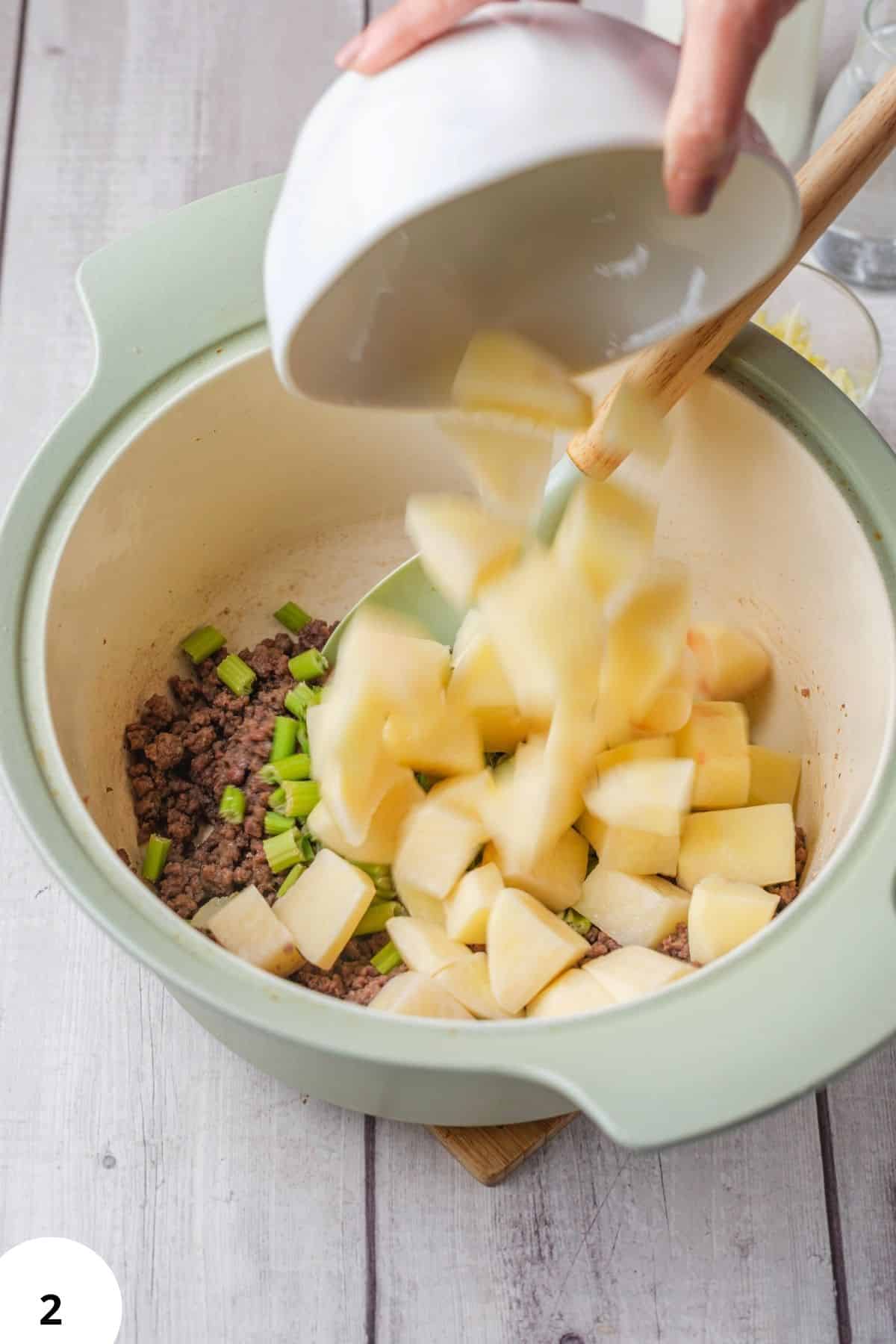 Dough being stretched and folded in a green mixing bowl for bread baking.