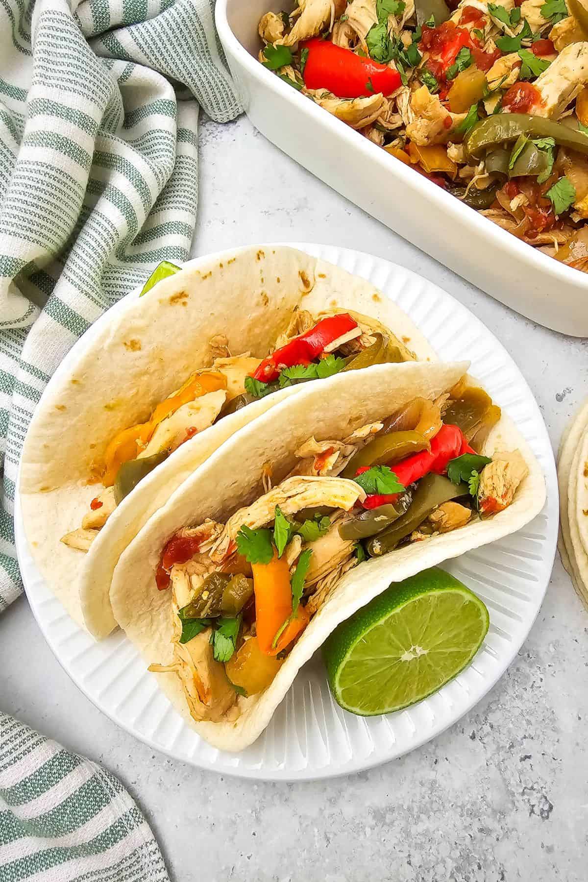 Fresh chicken fajitas in soft tortillas with peppers and onions.