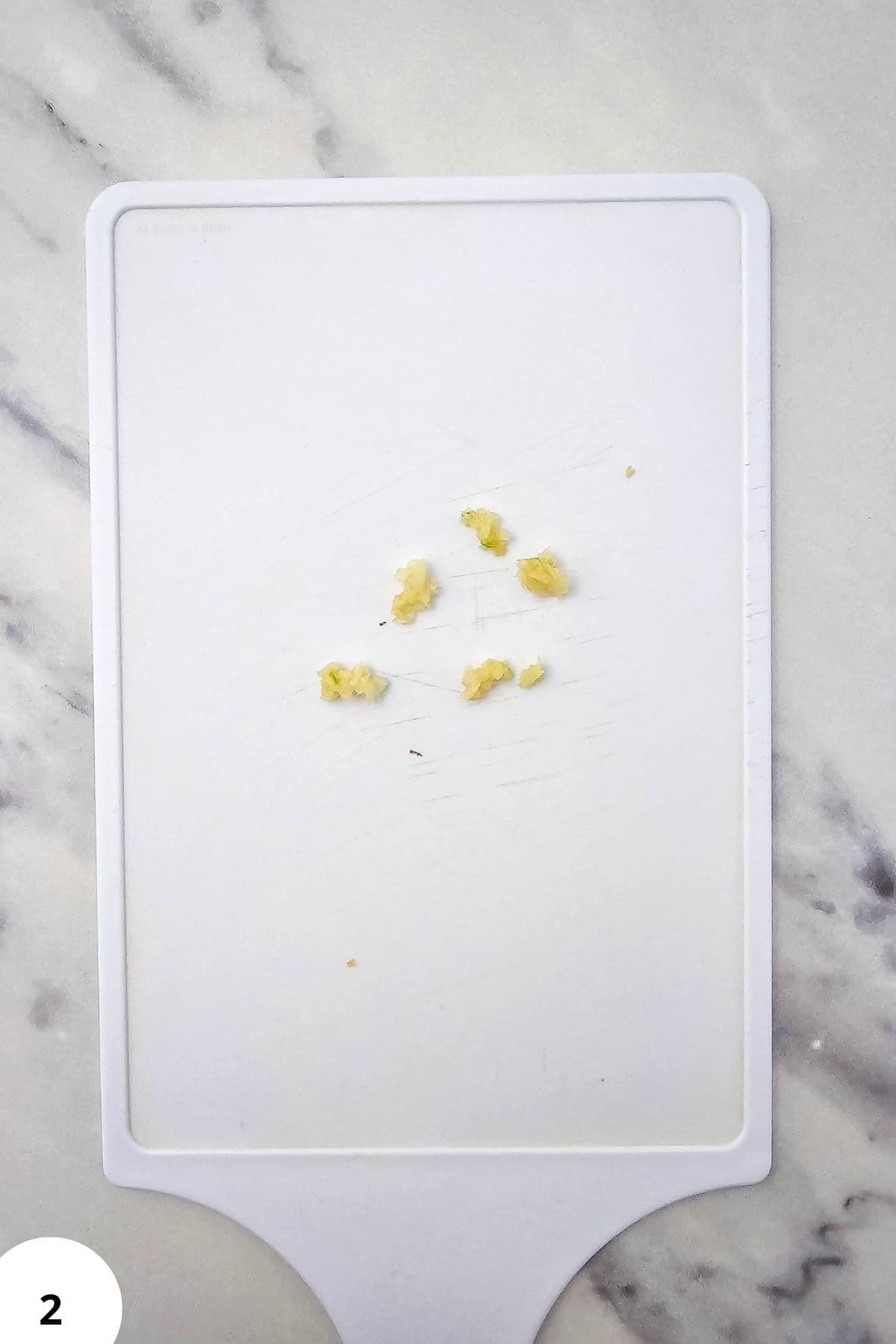 Demonstration of stretch and fold dough technique on a white surface.