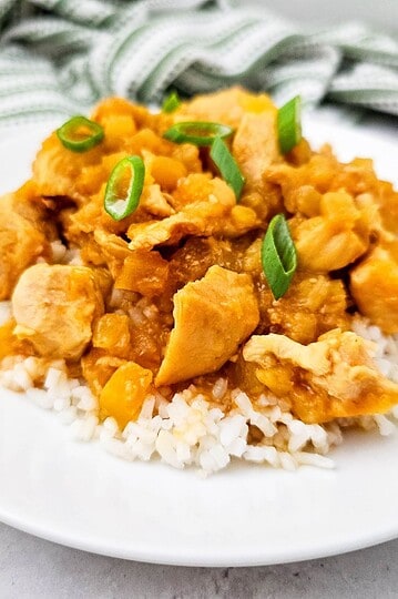 Delicious slow cooker Hawaiian chicken served over rice with green onions. Perfect for easy, flavorf.