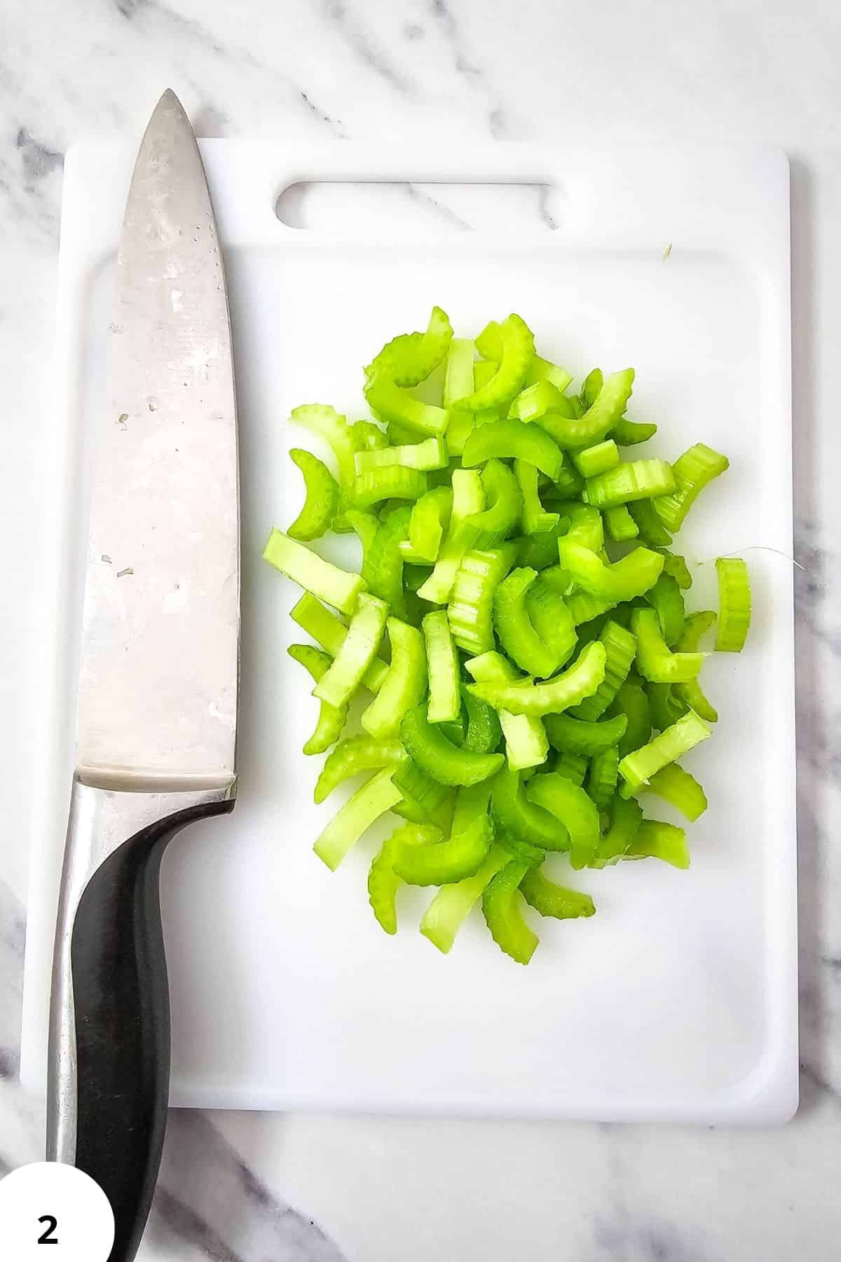 Chopped celery for summer vegetable soup preparation.