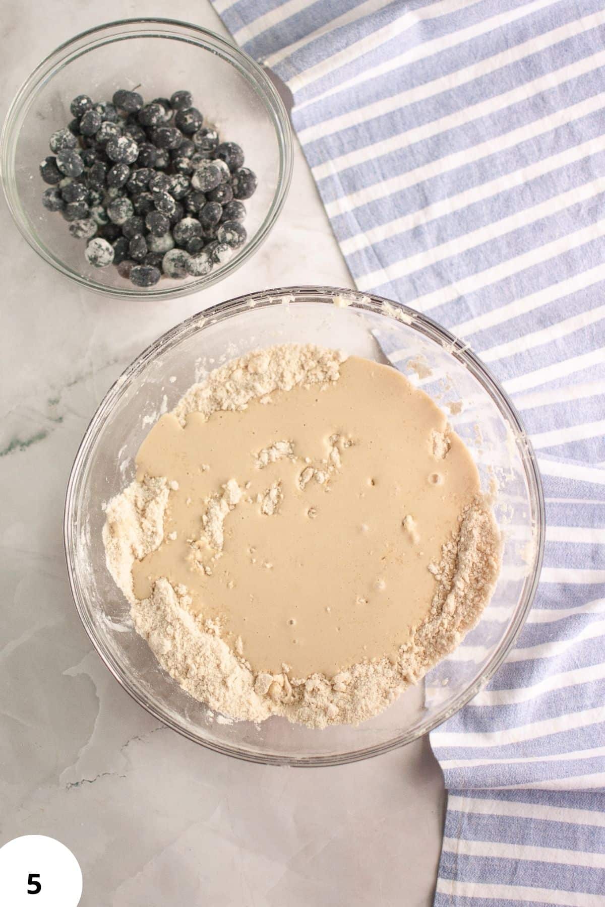 Fresh blueberries and dough for sourdough blueberry cream scones with stretch and fold technique.