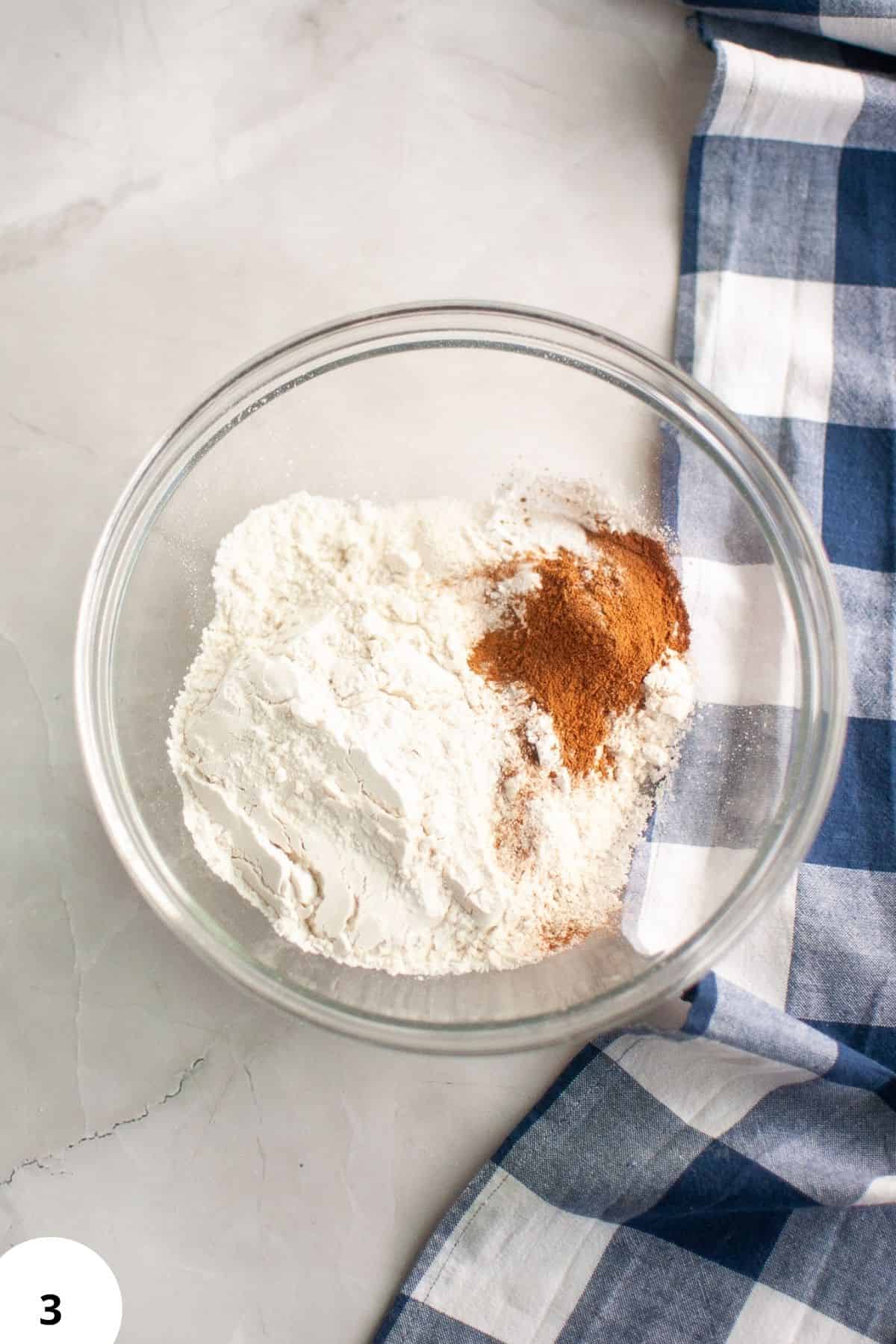 Mixing dry ingredients for banana muffins with sourdough discard and spices.