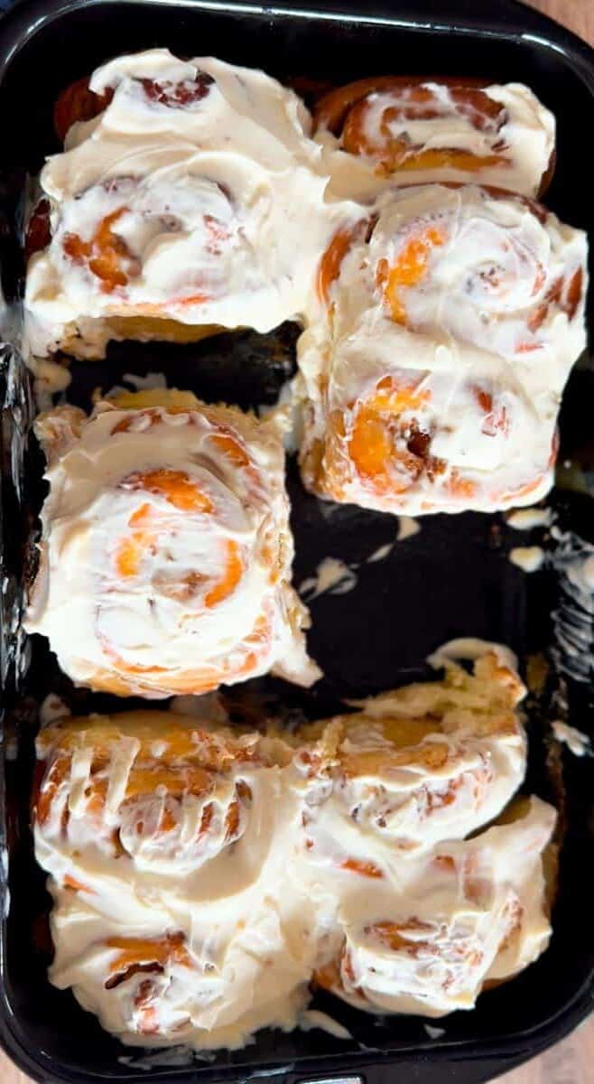 Fresh sushi rolls topped with cream cheese and orange fish roe.