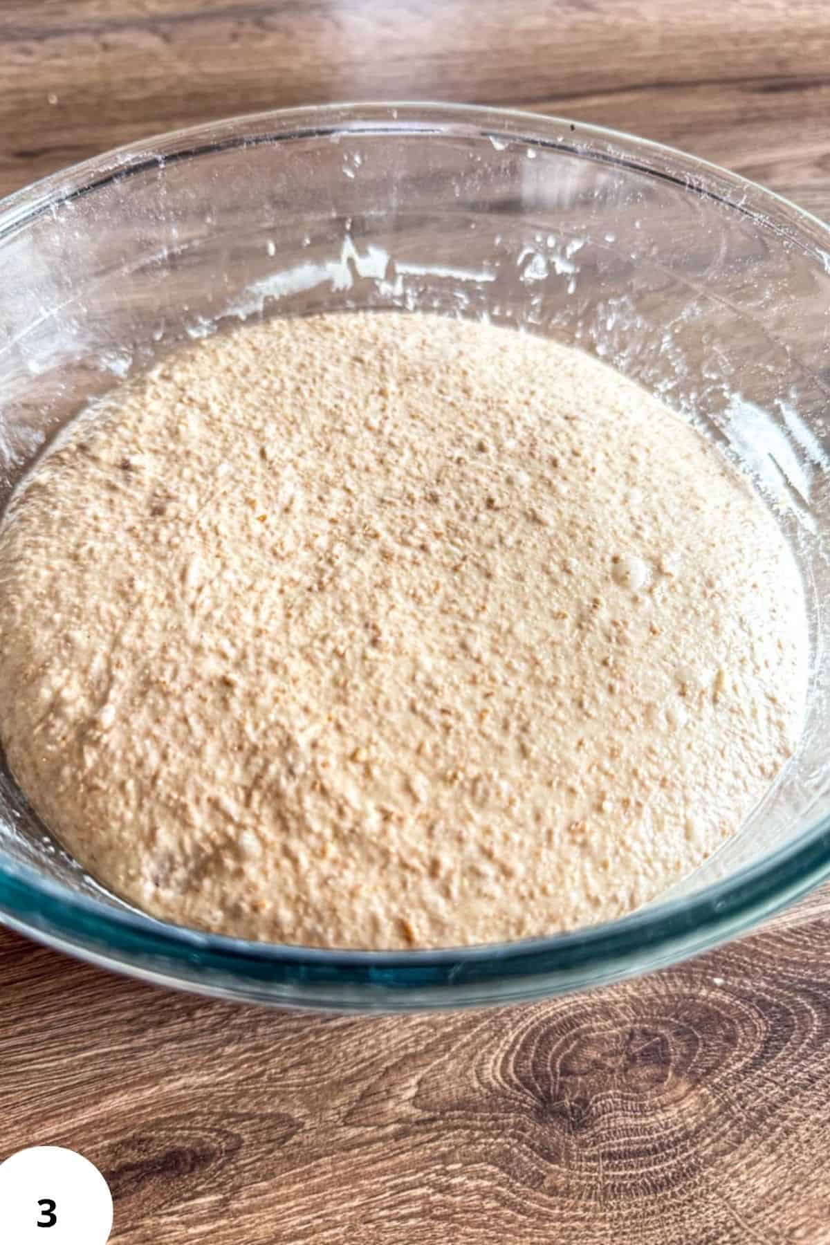 Close-up of whole grain spelt flour in a glass bowl for sourdough bread.