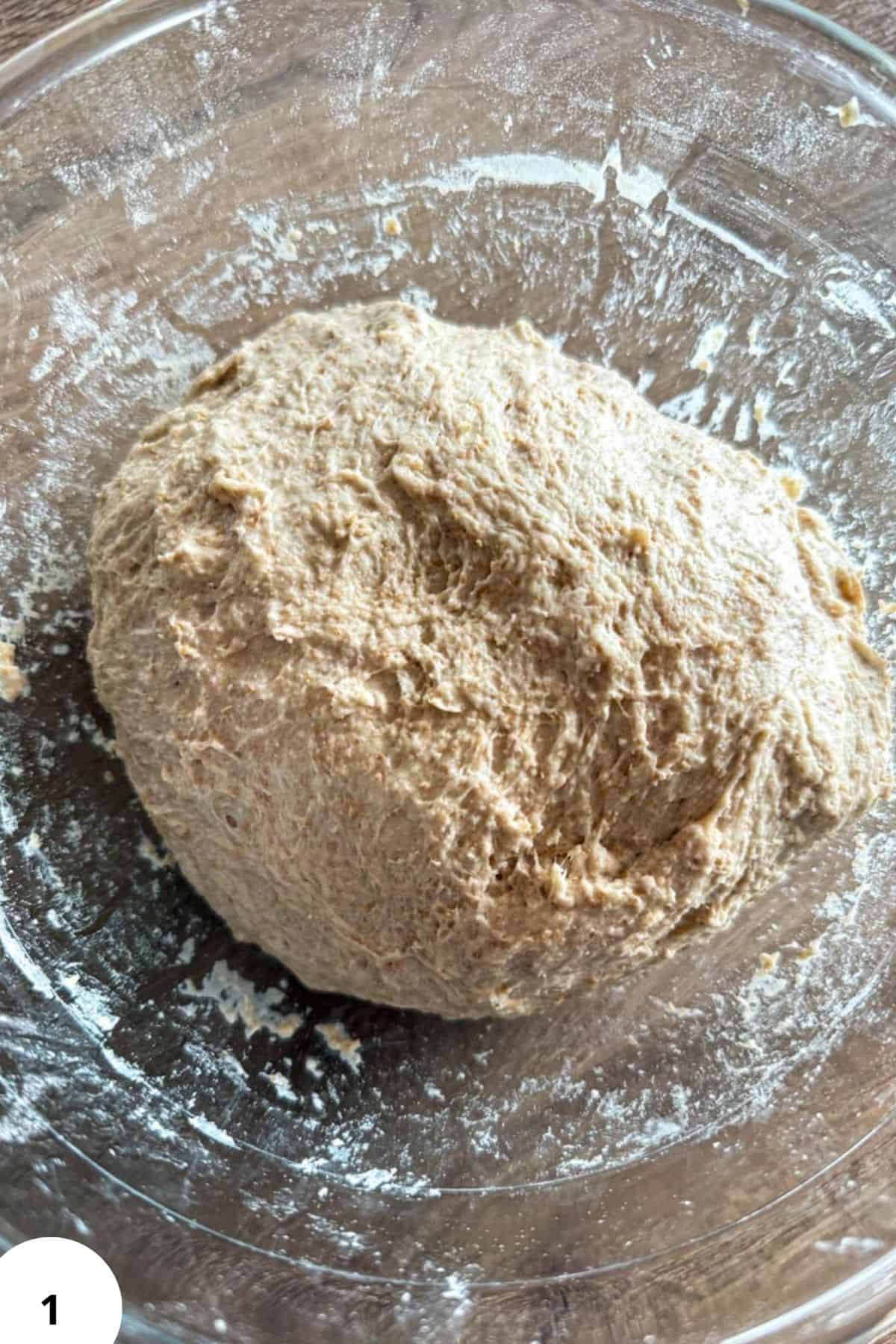Dinkelbrötchen dough during stretch and fold process for sourdough spelt rolls.