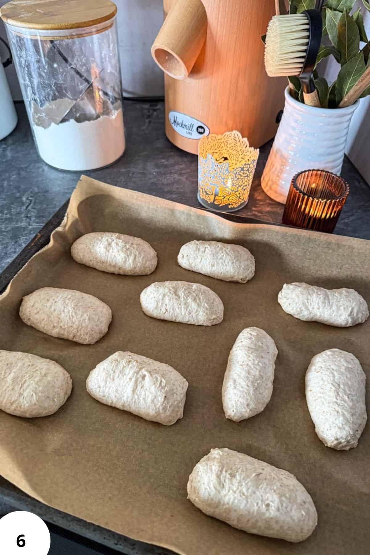 Dinkelbrötchen sourdough spelt rolls resting on baking paper.