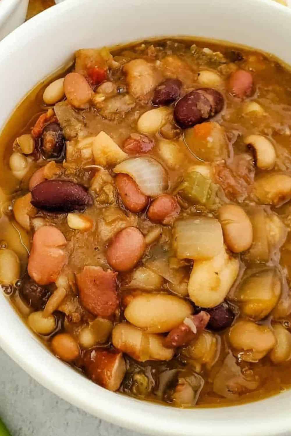 Hearty bean and vegetable soup with mixed beans, onions, and savory broth. Perfect for a nutritious,.