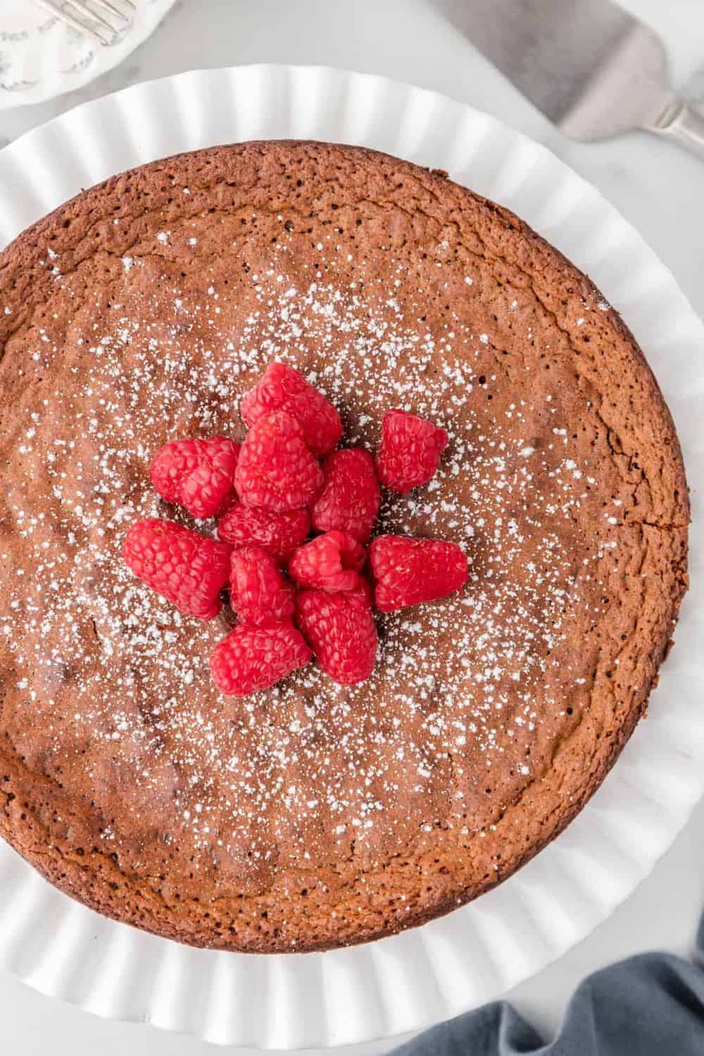 Chocolate cake with fresh raspberries on top.