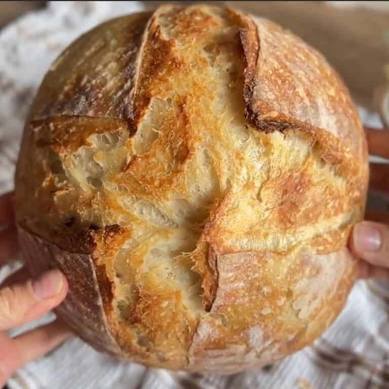 Fresh sourdough bread with a golden crust, showcasing stretch and fold technique.