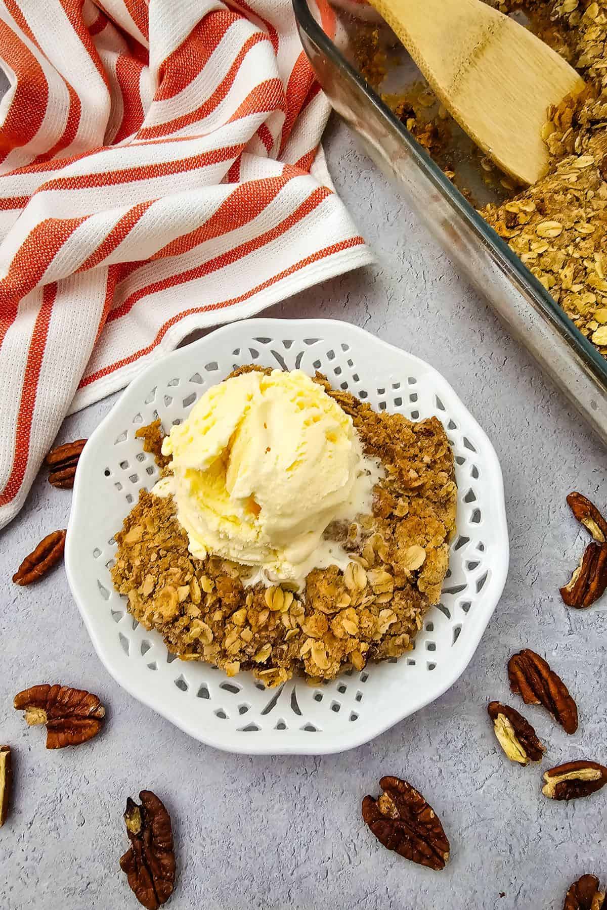 Delicious pumpkin pie crisp topped with buttery pecan oat crumble, perfect for fall desserts.