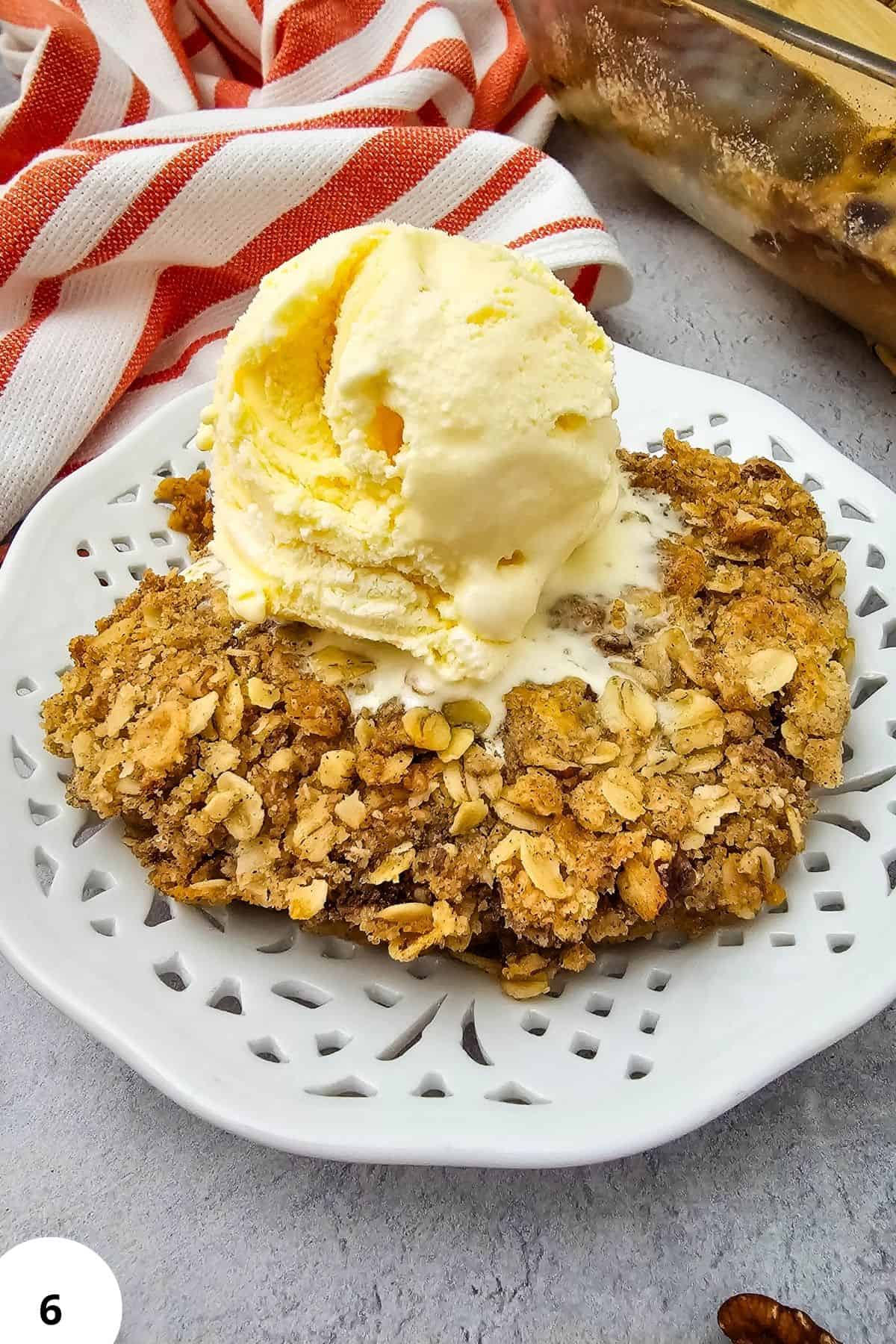 Delicious pumpkin pie crisp topped with buttery pecan oat crumble, served with a scoop of vanilla ic.