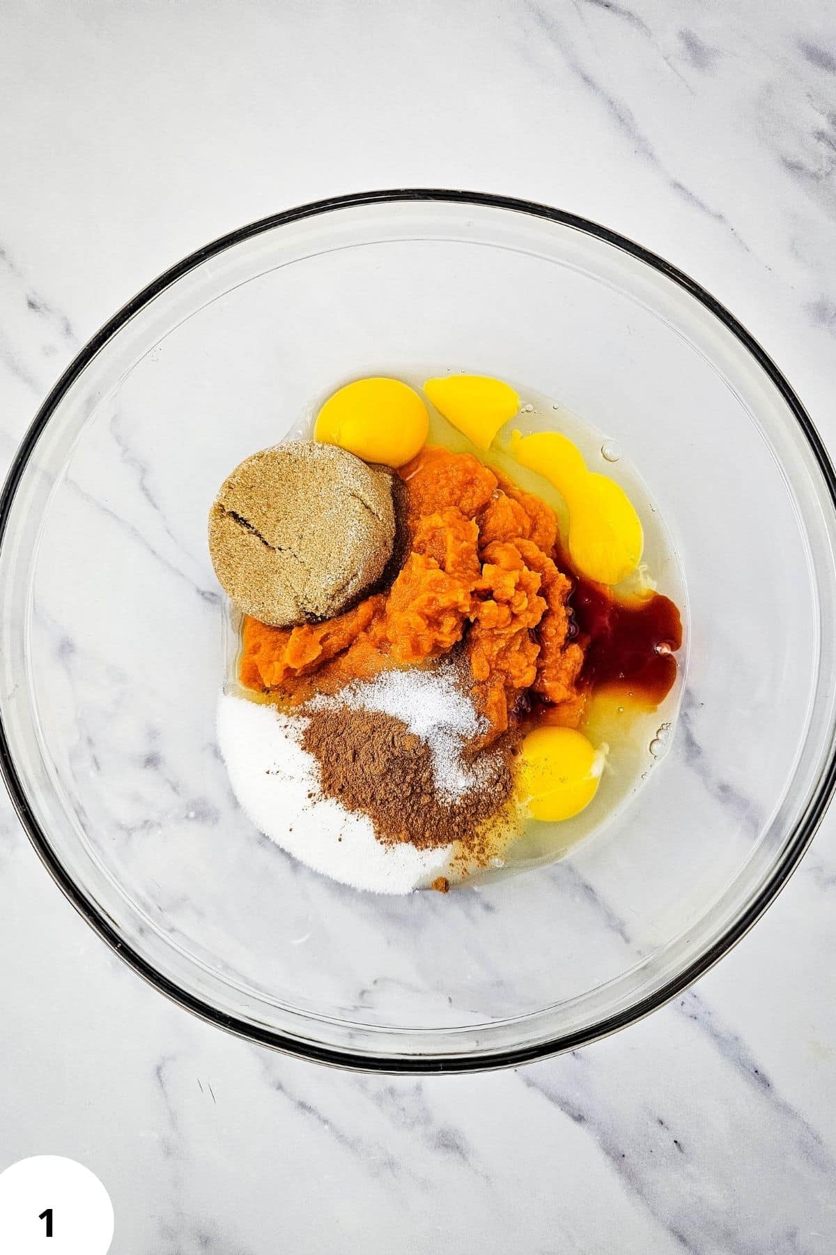 Ingredients for Pumpkin Pie Crisp in a glass bowl.