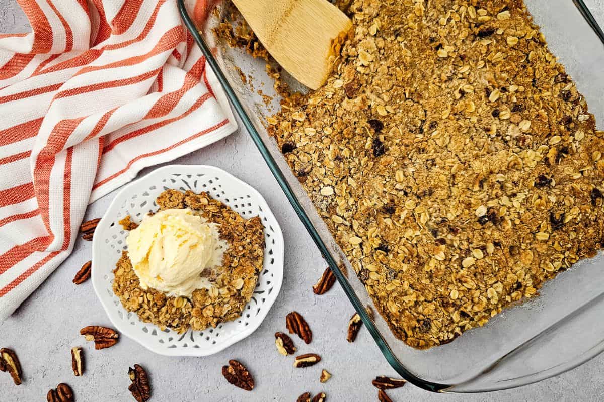 Delicious pumpkin pie crisp topped with buttery pecan oat crumble, perfect for fall desserts and coz.