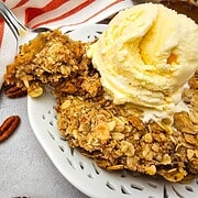 Delicious pumpkin pie crisp topped with buttery pecan oat crumble and a scoop of vanilla ice cream.