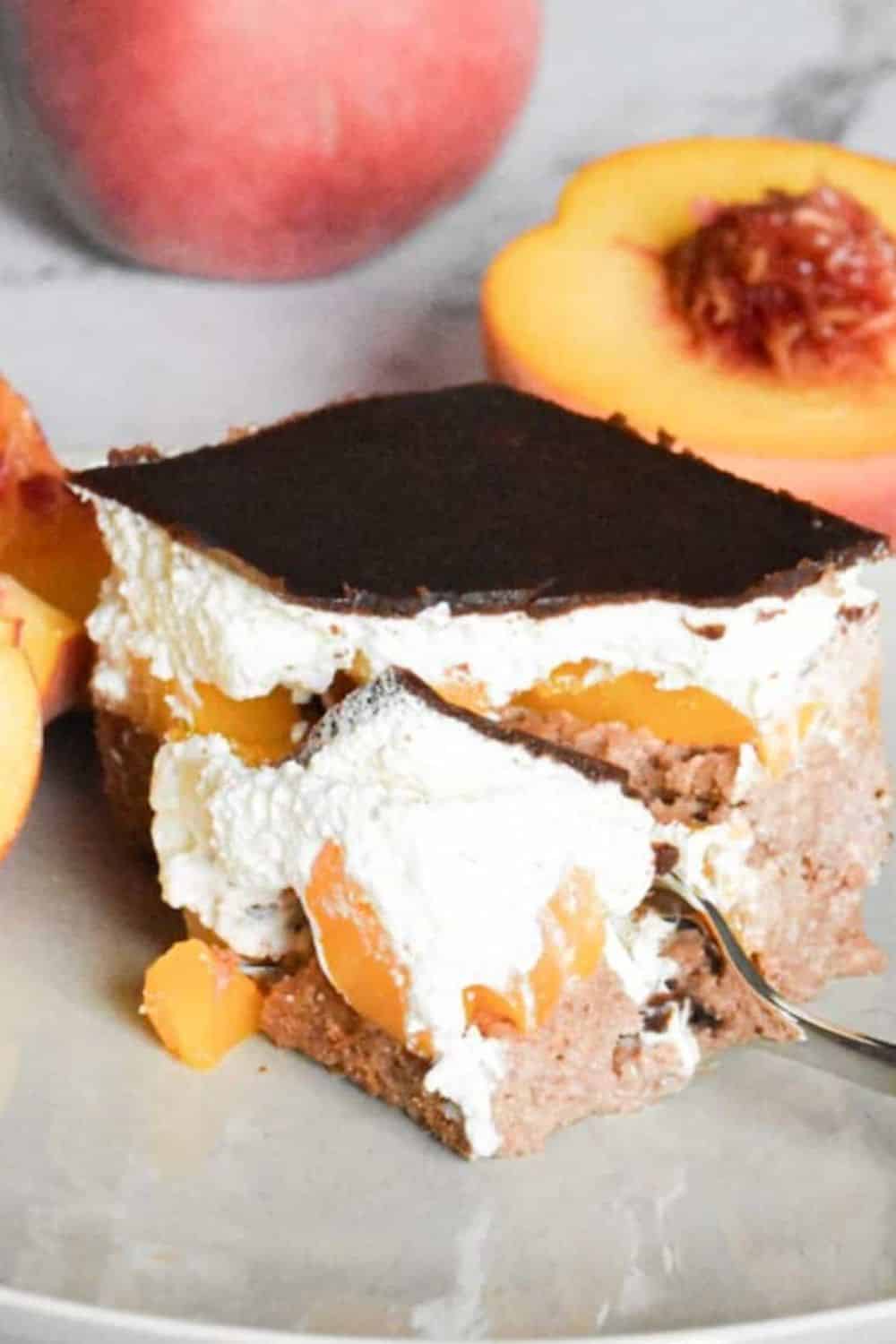 Peach and cream layered dessert with a dark chocolate topping.