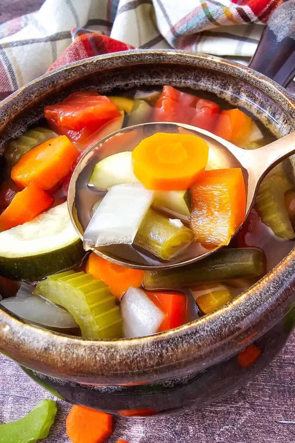 Healthy vegetable stew with carrots, zucchini, celery, and onions in broth.