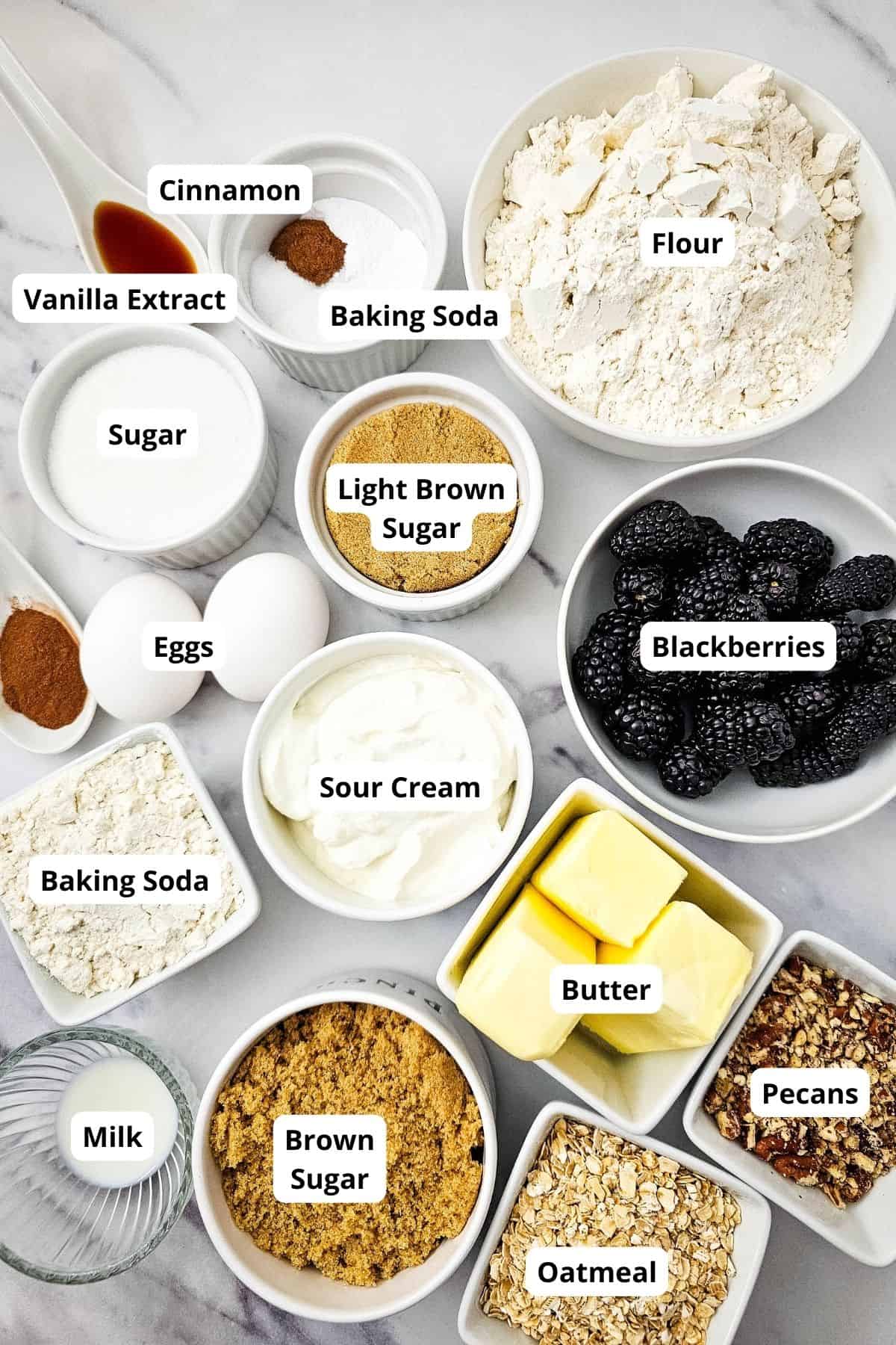 Ingredients for muffin batter including blackberries and streusel topping.