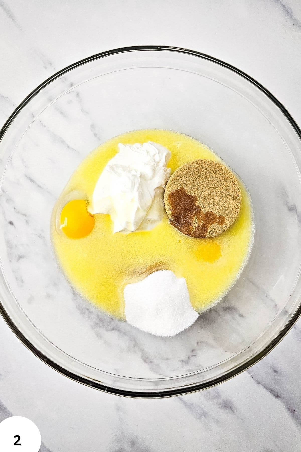 Mixing ingredients for blackberry muffin batter with streusel topping.